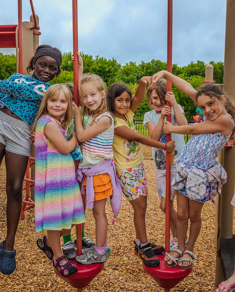 A group of school girls hanging out on the playground