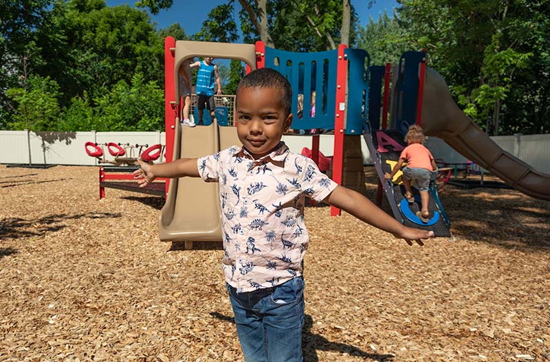 A young boy playing on the playground