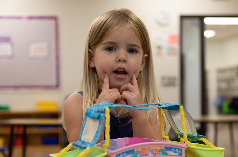 A young girl making a silly face at the camera